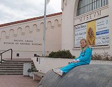girl sitting outside Pacific Grove museum