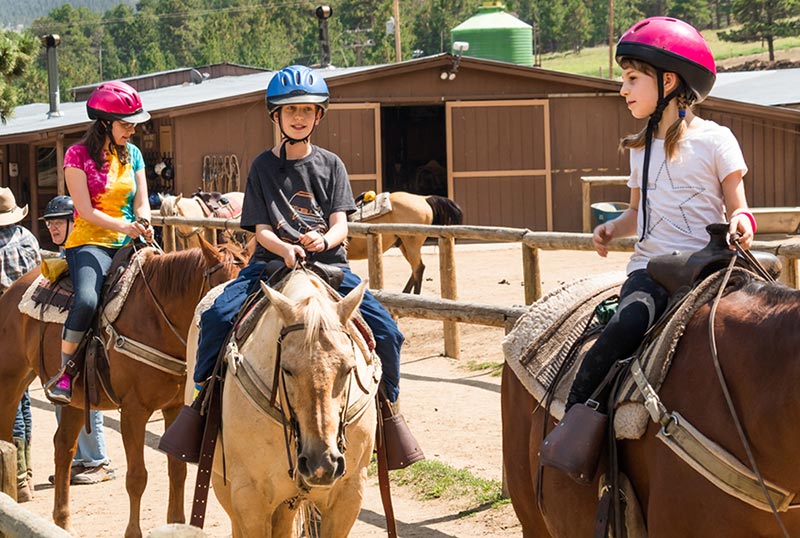 children traveling on horseback