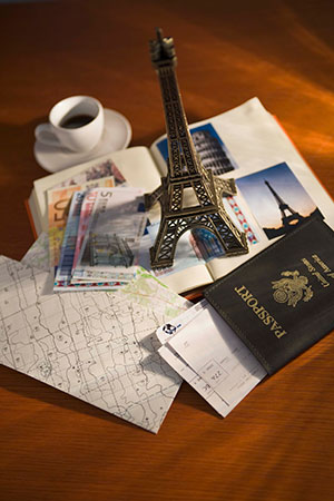 passport and replica of Eiffel tower