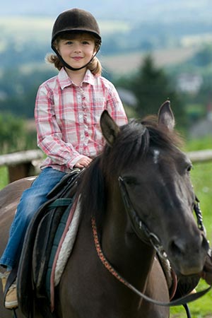 Child riding a horse at Grassy Creek Ranch